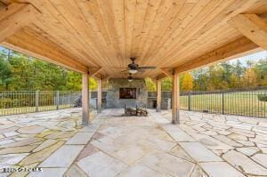 138 Lydon Ln, New Baltimore, NY 12087 - fenced backyard featuring a patio, ceiling fan, and exterior fireplace