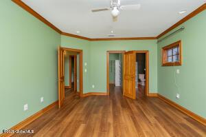 138 Lydon Ln, New Baltimore, NY 12087 - unfurnished bedroom featuring ornamental molding, baseboards, and wood finished floors