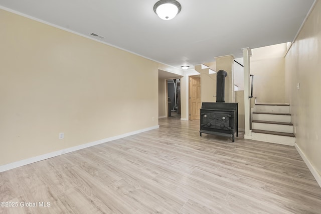 10610 State Highway 7, Worcester, NY 12064 - unfurnished living room with stairway, ornamental molding, baseboards, a wood stove, and wood finished floors