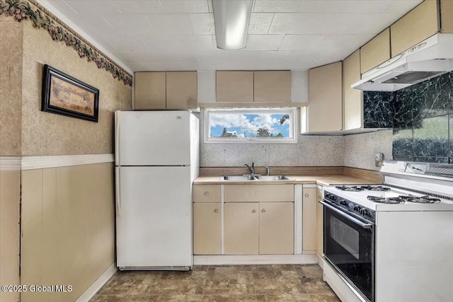 27 Washington Ave, Colonie, NY 12205 - kitchen with white appliances, a sink, under cabinet range hood, cream cabinets, and wainscoting