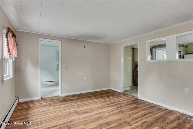 27 Washington Ave, Colonie, NY 12205 - empty room with a baseboard heating unit, wood finished floors, crown molding, and baseboards