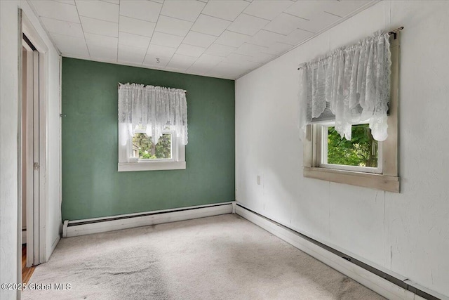 27 Washington Ave, Colonie, NY 12205 - carpeted empty room featuring healthy amount of natural light, baseboard heating, and a baseboard heating unit