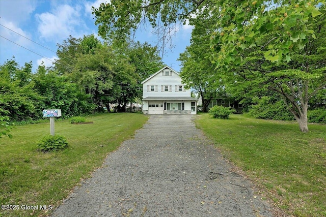 27 Washington Ave, Colonie, NY 12205 - view of front of house with a front yard, asphalt driveway, and a garage