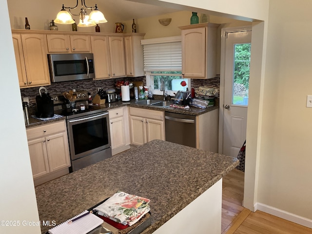 129 Okara Dr, Guilderland, NY 12303 - kitchen featuring appliances with stainless steel finishes, a sink, light wood finished floors, light brown cabinets, and healthy amount of natural light