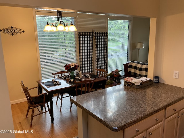 129 Okara Dr, Guilderland, NY 12303 - kitchen with dark countertops, light wood-style flooring, a chandelier, and pendant lighting