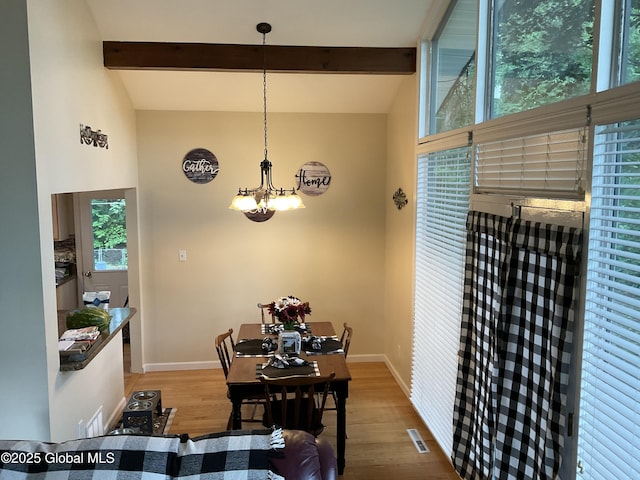 129 Okara Dr, Guilderland, NY 12303 - dining space featuring wood finished floors, a chandelier, baseboards, beamed ceiling, and healthy amount of natural light