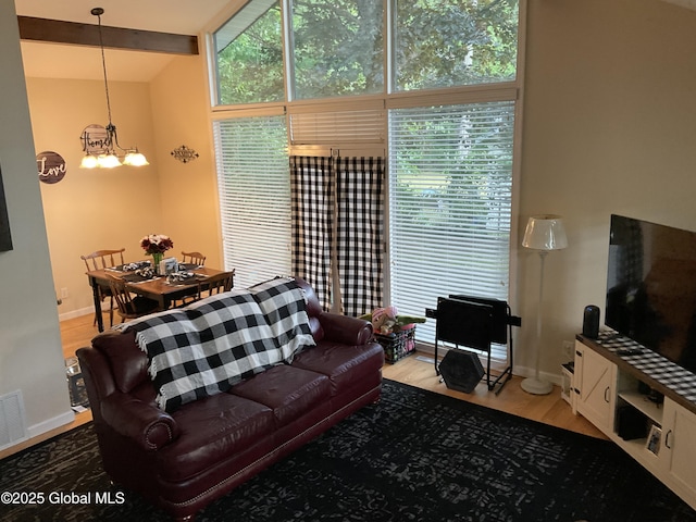 129 Okara Dr, Guilderland, NY 12303 - living room featuring baseboards, a chandelier, and wood finished floors