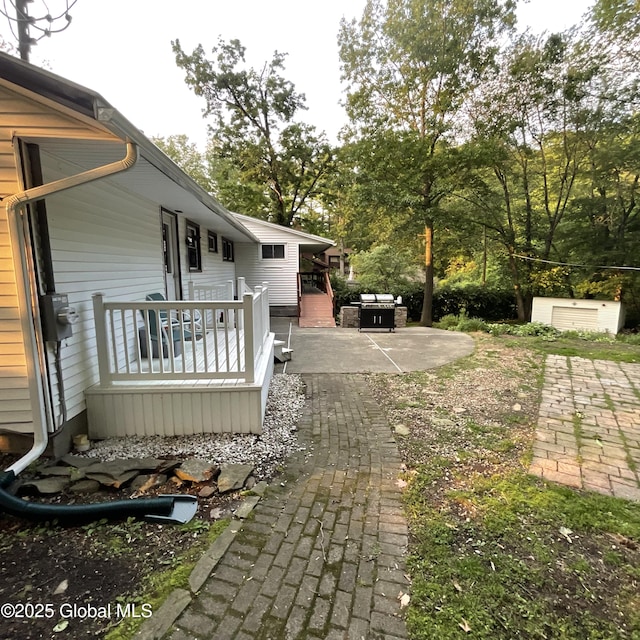 129 Okara Dr, Guilderland, NY 12303 - view of yard featuring a wooden deck, a patio area, and view of scattered trees