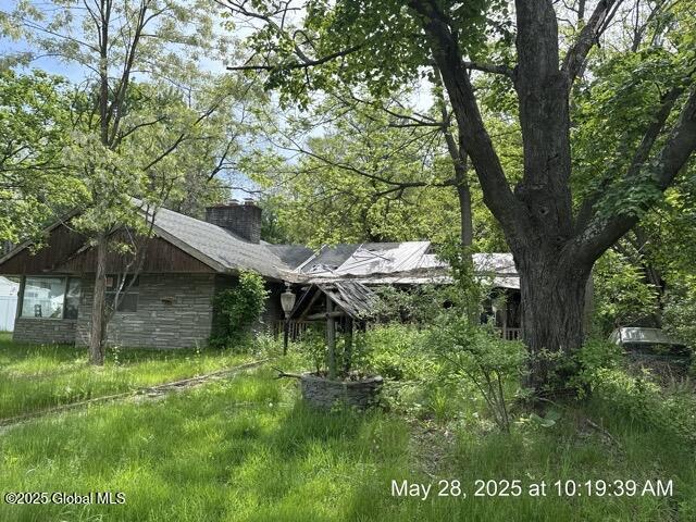 6 Sumter Ave, Guilderland, NY 12203 - back of property with a chimney and stone siding