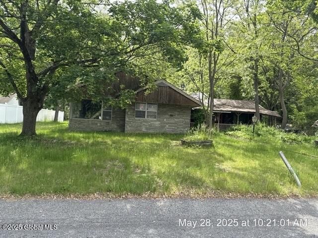 6 Sumter Ave, Guilderland, NY 12203 - view of home's exterior with stone siding and a wooded view