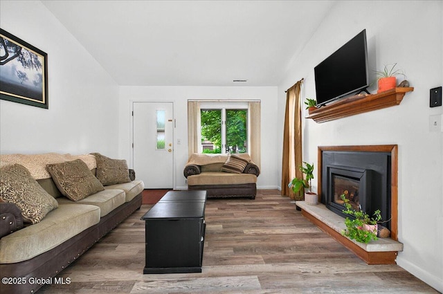 60 Tallow Wood Dr, Clifton Park, NY 12065 - living area with wood finished floors, a fireplace with raised hearth, and baseboards