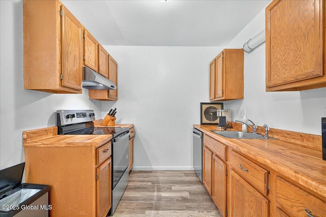 60 Tallow Wood Dr, Clifton Park, NY 12065 - kitchen featuring under cabinet range hood, appliances with stainless steel finishes, a sink, light wood-type flooring, and butcher block counters