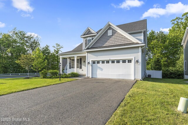 2 Hillard Ln, Colonie, NY 12110 - view of front of property featuring asphalt driveway, a garage, roof with shingles, and covered porch