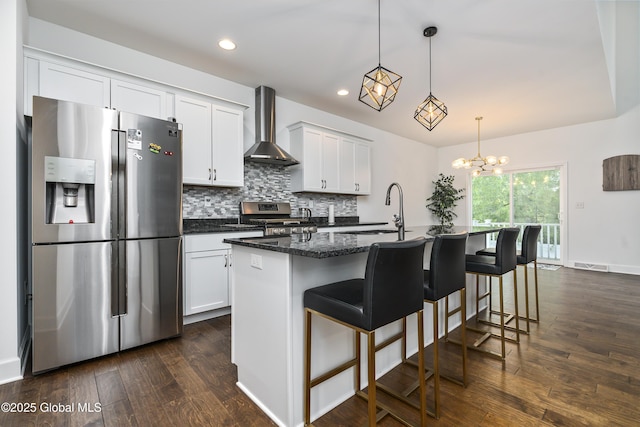 2 Hillard Ln, Colonie, NY 12110 - kitchen featuring stainless steel appliances, wall chimney exhaust hood, a sink, an island with sink, and decorative backsplash