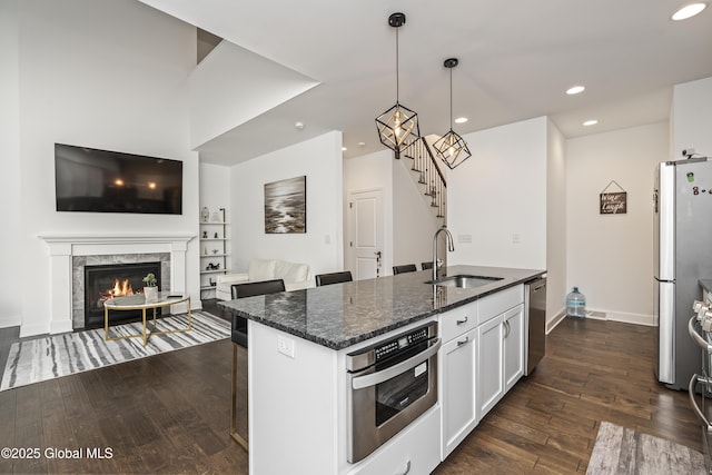 2 Hillard Ln, Colonie, NY 12110 - kitchen featuring a sink, stainless steel appliances, dark wood-style floors, recessed lighting, and dark stone countertops