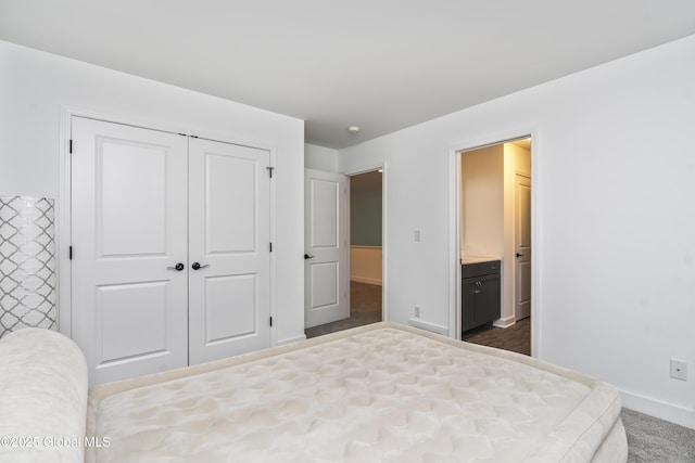 2 Hillard Ln, Colonie, NY 12110 - bedroom featuring a closet, baseboards, ensuite bath, and dark colored carpet