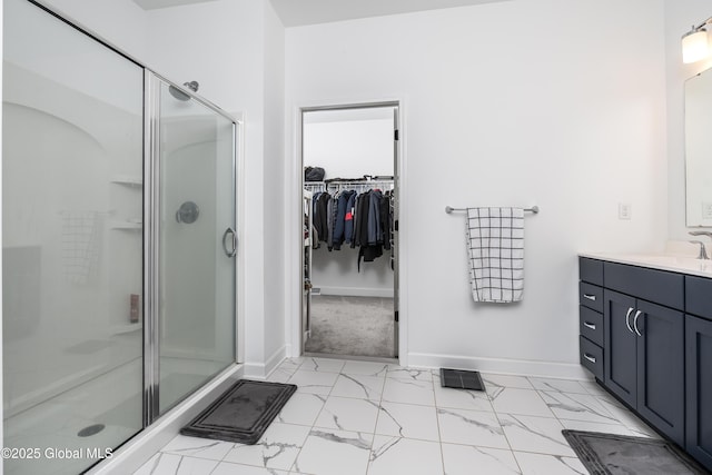 2 Hillard Ln, Colonie, NY 12110 - full bathroom featuring marble finish flooring, a stall shower, vanity, a spacious closet, and baseboards