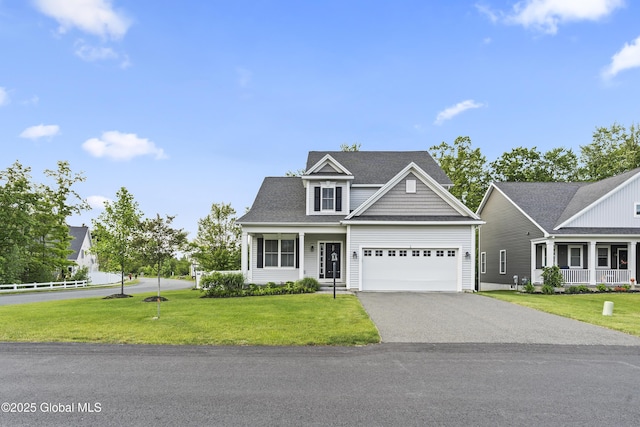 2 Hillard Ln, Colonie, NY 12110 - traditional-style house with asphalt driveway, a garage, and covered porch