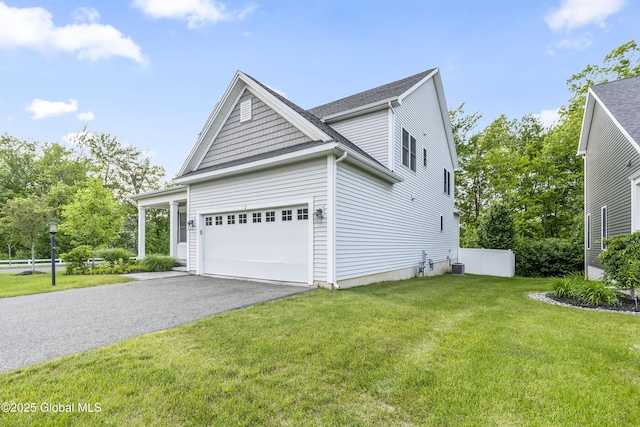 2 Hillard Ln, Colonie, NY 12110 - view of side of property featuring asphalt driveway, a lawn, cooling unit, and a garage