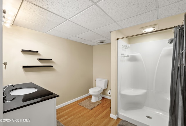 3119 State Route 150, Schodack, NY 12063 - full bathroom featuring a paneled ceiling, wood finished floors, toilet, a shower stall, and baseboards
