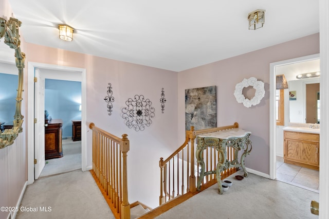 3119 State Route 150, Schodack, NY 12063 - hallway with an upstairs landing, light colored carpet, baseboards, and a sink