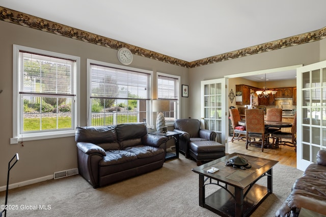 3119 State Route 150, Schodack, NY 12063 - living area featuring plenty of natural light, a chandelier, and baseboards