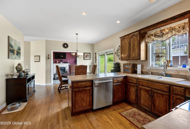 3119 State Route 150, Schodack, NY 12063 - kitchen with dishwasher, a sink, wood finished floors, a peninsula, and hanging light fixtures