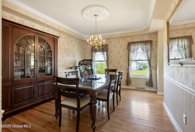 3119 State Route 150, Schodack, NY 12063 - dining space featuring wallpapered walls, a chandelier, light wood finished floors, and crown molding