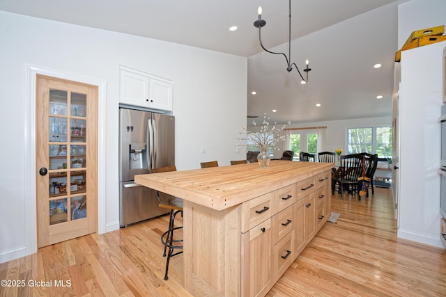 17 Ringwald Rd, Coeymans, NY 12046 - kitchen featuring stainless steel refrigerator with ice dispenser, wood counters, a breakfast bar, light wood-style flooring, and recessed lighting