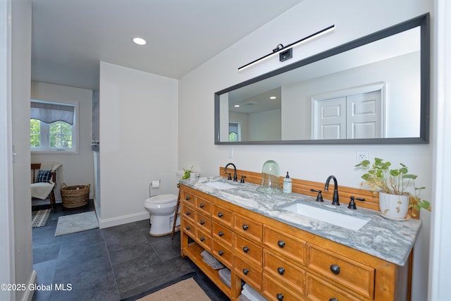 17 Ringwald Rd, Coeymans, NY 12046 - bathroom featuring double vanity, toilet, recessed lighting, baseboards, and tile patterned floors