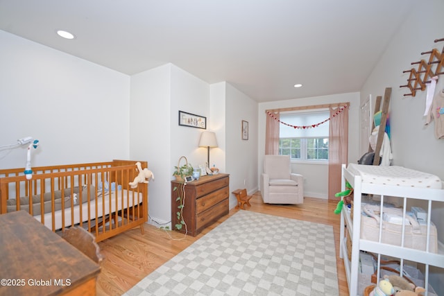 17 Ringwald Rd, Coeymans, NY 12046 - bedroom with wood finished floors, recessed lighting, baseboards, and a crib