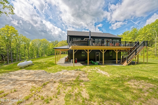 17 Ringwald Rd, Coeymans, NY 12046 - rear view of property with a deck, stairway, board and batten siding, and a lawn