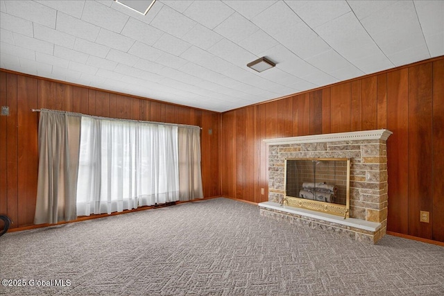 149 Wilton Rd, Greenfield, NY 12833 - unfurnished living room with wooden walls, a fireplace with raised hearth, and carpet floors
