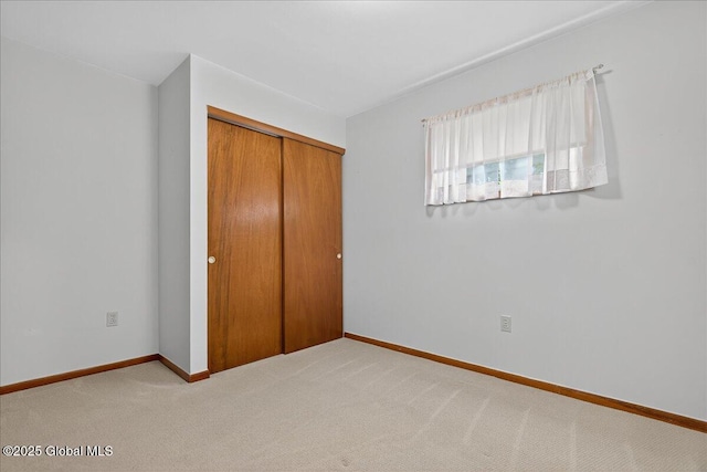 149 Wilton Rd, Greenfield, NY 12833 - unfurnished bedroom with carpet flooring, a closet, and baseboards