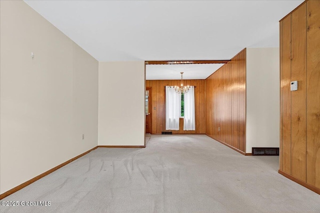 149 Wilton Rd, Greenfield, NY 12833 - empty room featuring a chandelier, baseboards, light carpet, and wooden walls