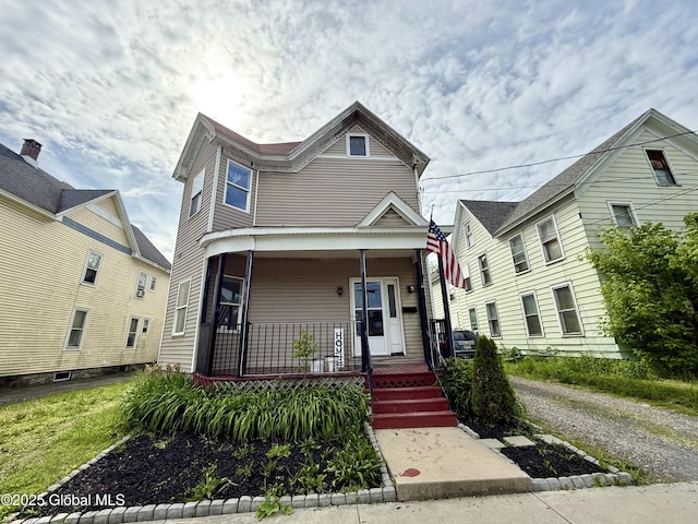 243 N Perry St, Johnstown, NY 12095 - view of front facade with a porch
