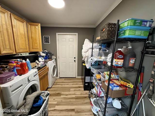 243 N Perry St, Johnstown, NY 12095 - laundry area featuring crown molding, light wood-type flooring, separate washer and dryer, and cabinet space