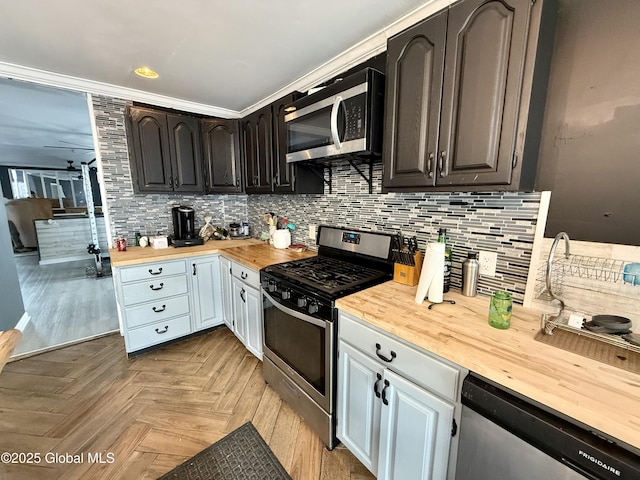 243 N Perry St, Johnstown, NY 12095 - kitchen featuring stainless steel appliances, wooden counters, backsplash, and white cabinetry