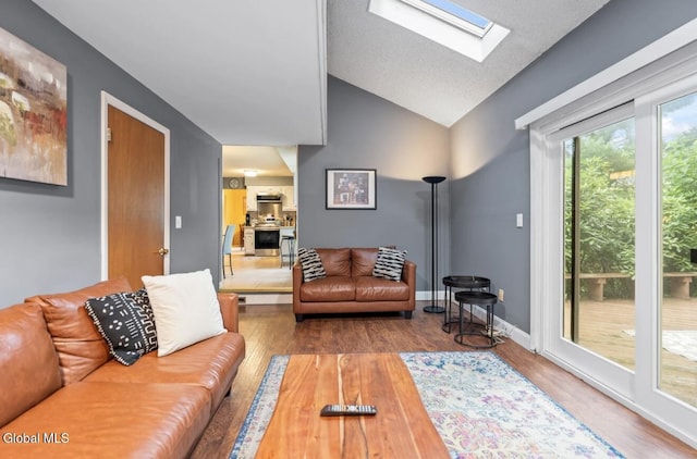 7 Hawthorn Cir, Albany, NY 12203 - living area with a skylight, vaulted ceiling, and wood finished floors