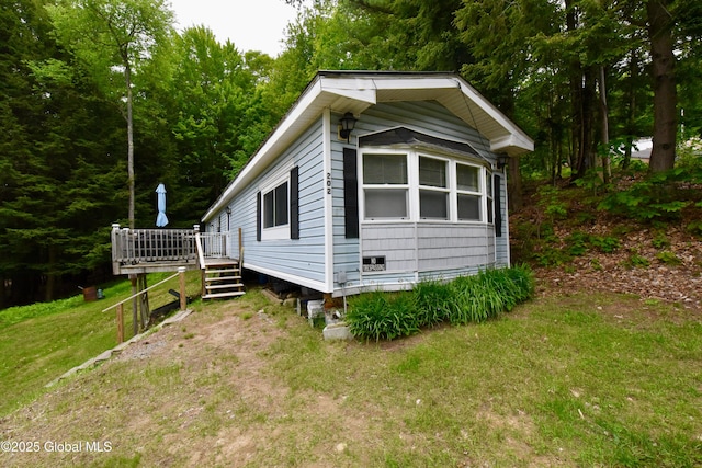 202 Lakeland Rd, Edinburg, NY 12835 - view of side of property with a deck and a lawn