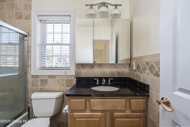 1112 Western Ave Unit 3, Albany, NY 12203 - bathroom with tile walls, toilet, vanity, healthy amount of natural light, and shower / bath combination with glass door