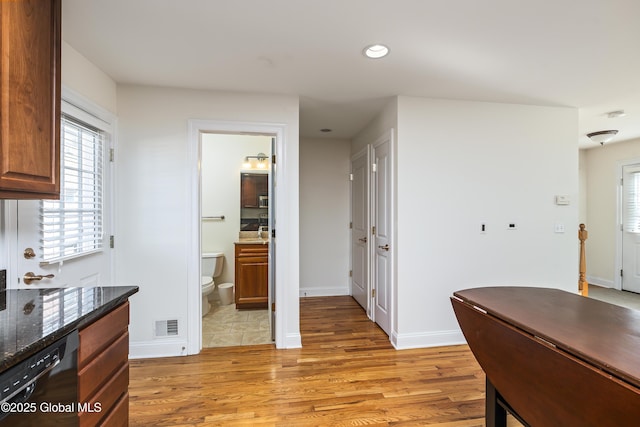 1112 Western Ave Unit 3, Albany, NY 12203 - kitchen with black dishwasher, light wood-style flooring, recessed lighting, dark stone countertops, and baseboards