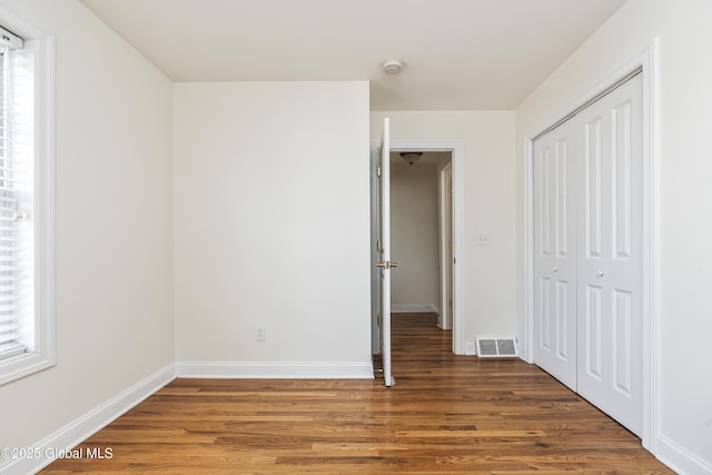 1112 Western Ave Unit 3, Albany, NY 12203 - unfurnished bedroom featuring wood finished floors, a closet, and baseboards