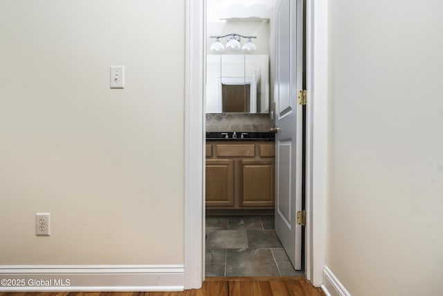 1112 Western Ave Unit 3, Albany, NY 12203 - corridor with dark stone finish floors, a sink, and baseboards