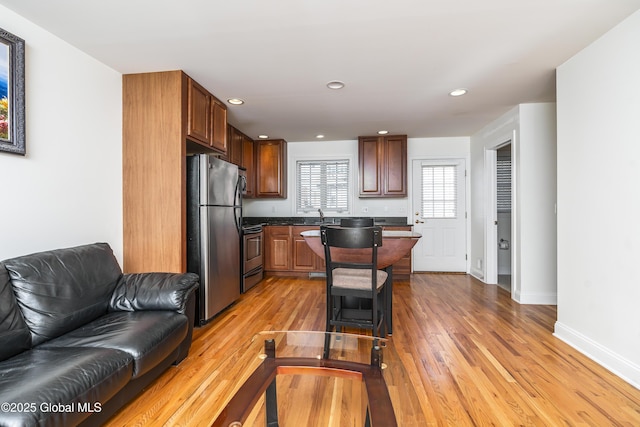 1112 Western Ave Unit 3, Albany, NY 12203 - kitchen with appliances with stainless steel finishes, open floor plan, dark countertops, light wood-style flooring, and recessed lighting