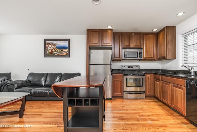 1112 Western Ave Unit 3, Albany, NY 12203 - kitchen featuring stainless steel appliances, a sink, open floor plan, recessed lighting, and light wood-style flooring