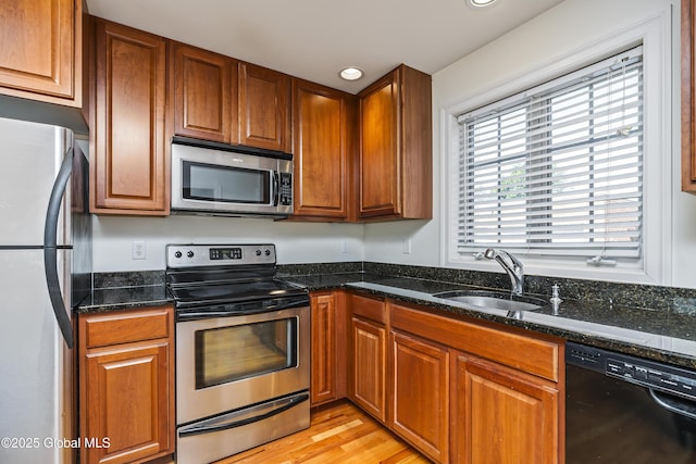 1112 Western Ave Unit 3, Albany, NY 12203 - kitchen featuring stainless steel appliances, a sink, brown cabinets, dark stone counters, and recessed lighting