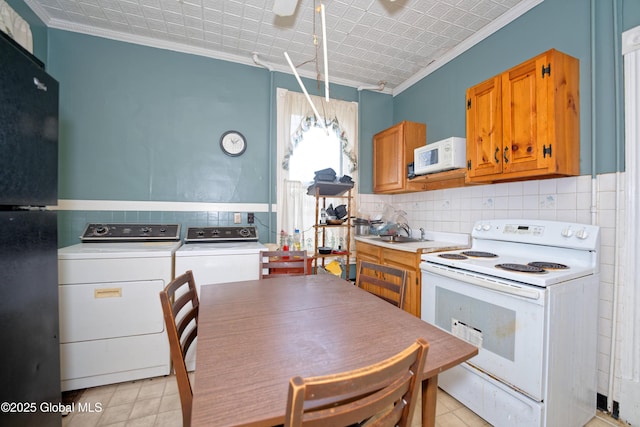 6 123rd St, Troy, NY 12182 - kitchen featuring white appliances, crown molding, backsplash, independent washer and dryer, and light countertops