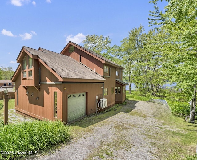 2555 County Highway 22, Exeter, NY 13315 - view of side of property featuring a shingled roof, ac unit, driveway, and an attached garage
