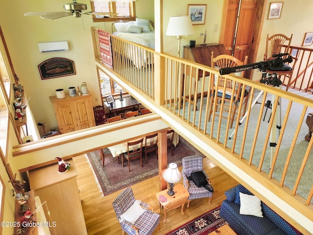 2555 County Highway 22, Exeter, NY 13315 - stairway featuring wood finished floors, a wall mounted AC, and a ceiling fan
